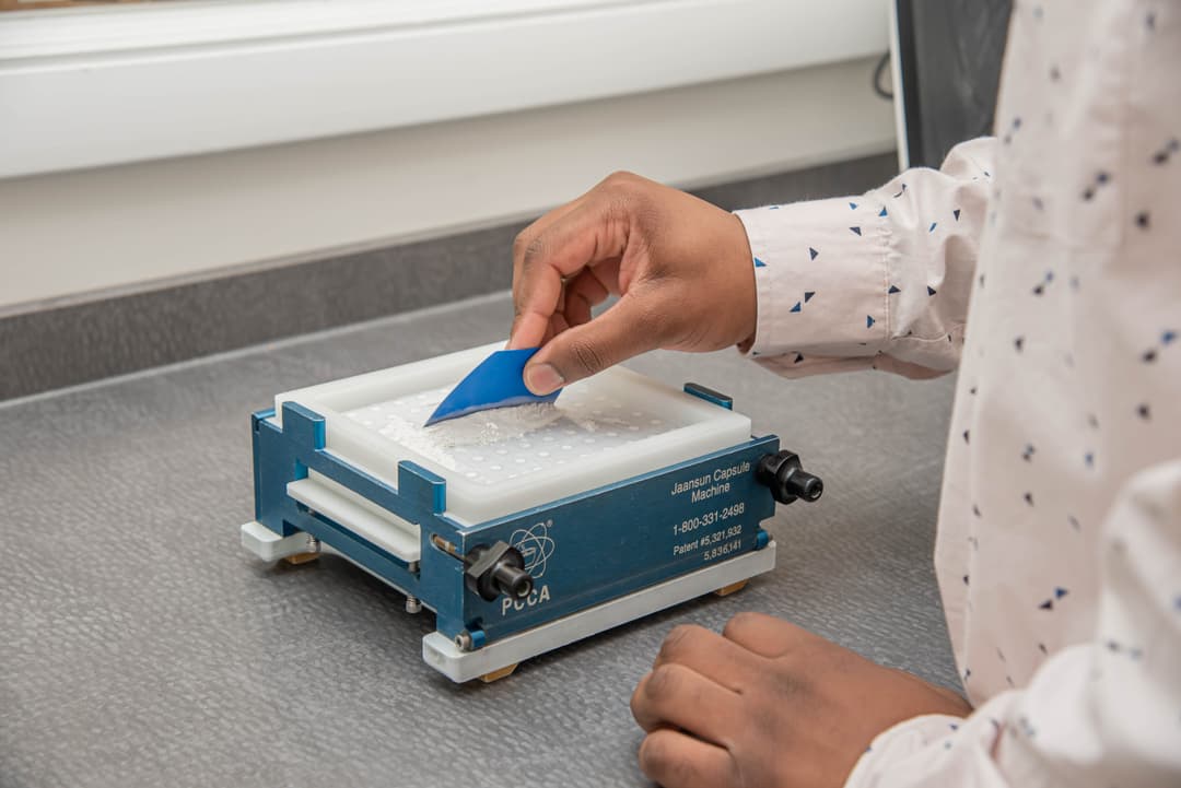 Pharmacist preparing compounded medication